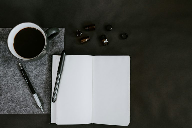 Flat lay of a coffee mug and pencils