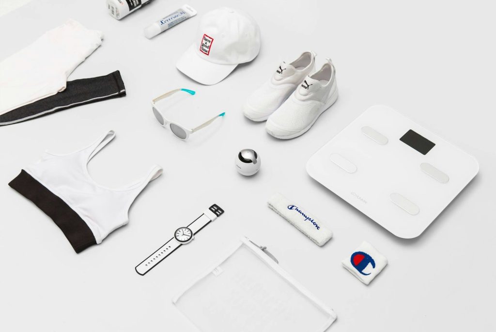 Flat lay of sneakers, cap, leggings and sports bra