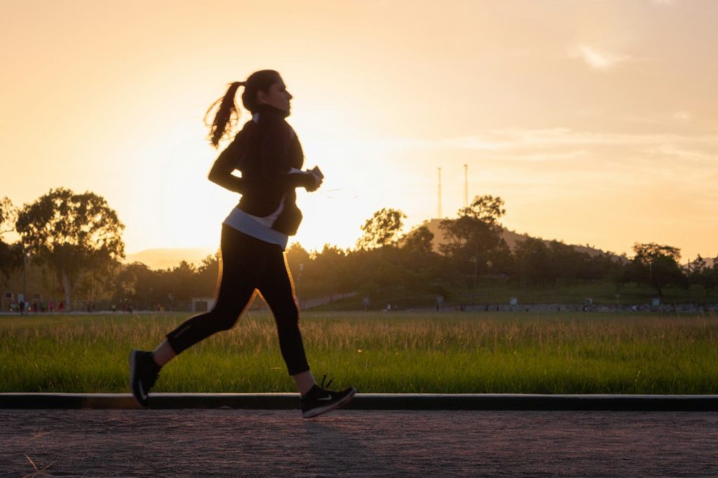 Woman running on a path in golden hour light