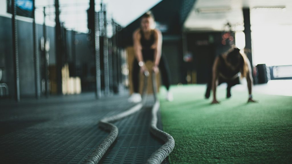 Two people exercising together in a gym