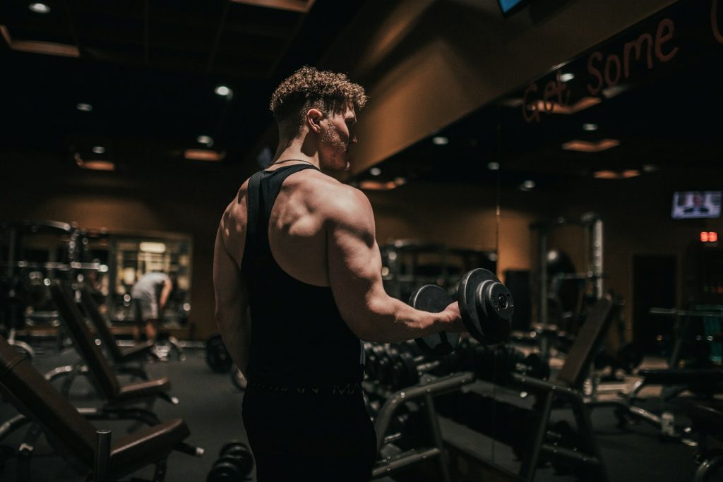 Man holding a dumbbell in a gym