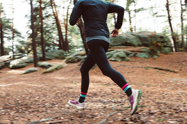 Trail runner on a woodland path