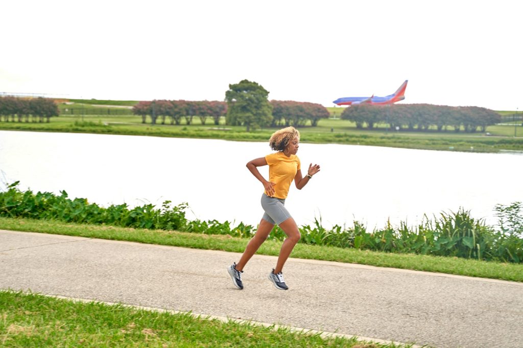 Woman running along a lakeside path