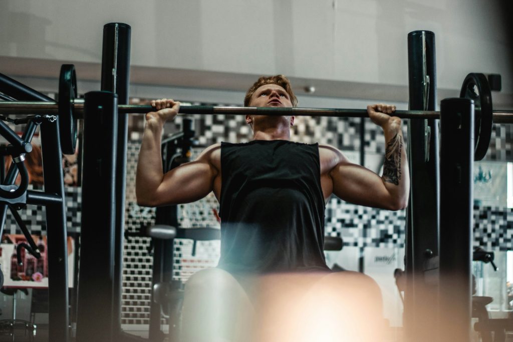 Man lifting a barbell in a gym