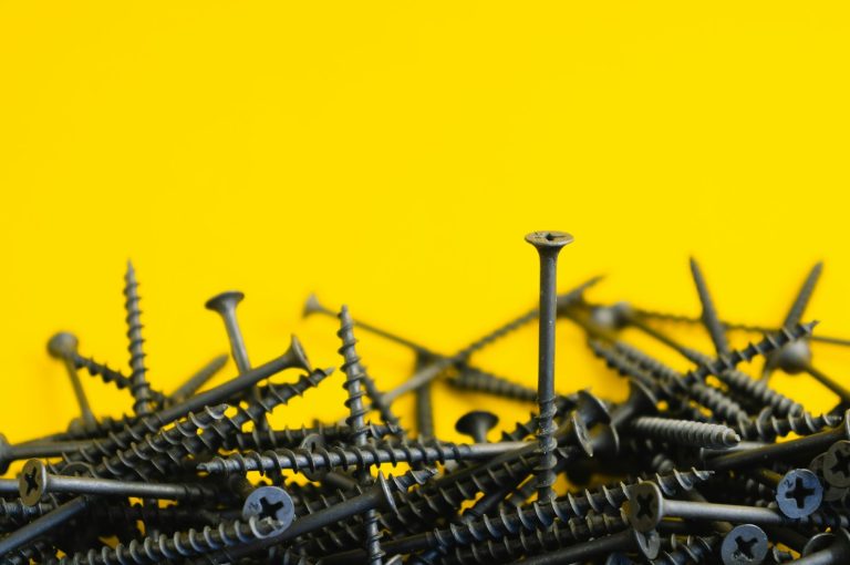 Metal nails on a yellow surface