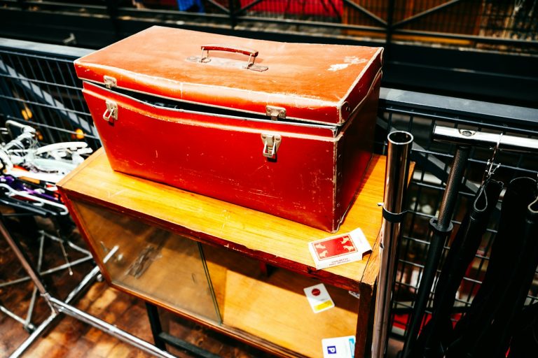 Red toolbox on a wooden cabinet