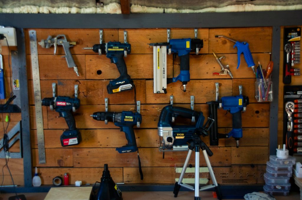Wooden wall with tools hanging on it