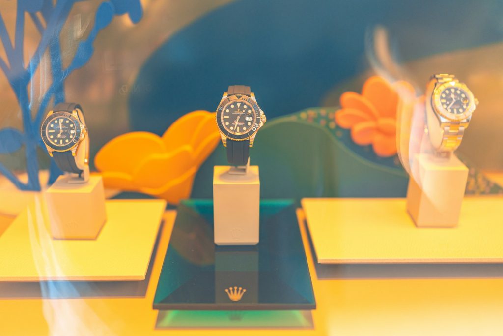 Three watches displayed on stands