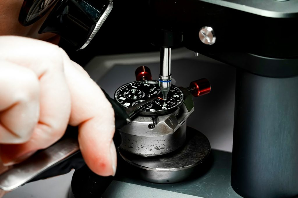 Person working on a watch at the bench