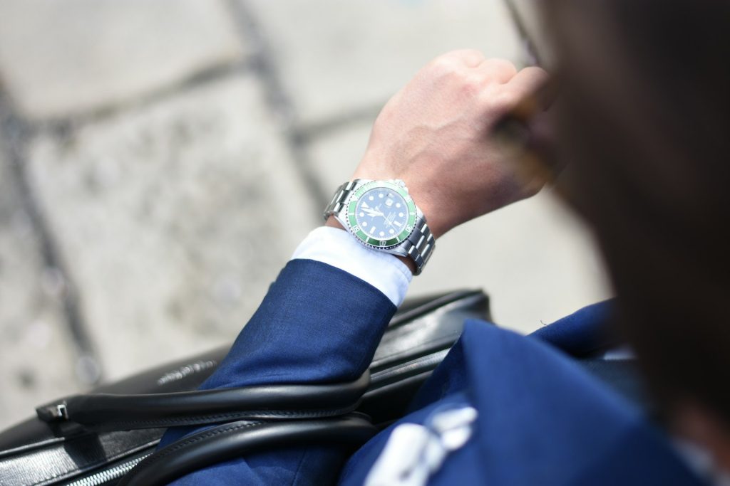 Person looking at a silver analog watch