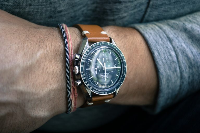 Chronograph watch with brown leather strap on wrist