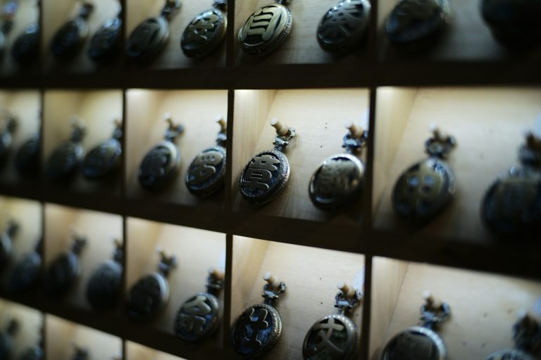 Antique pocket watches displayed on shelves