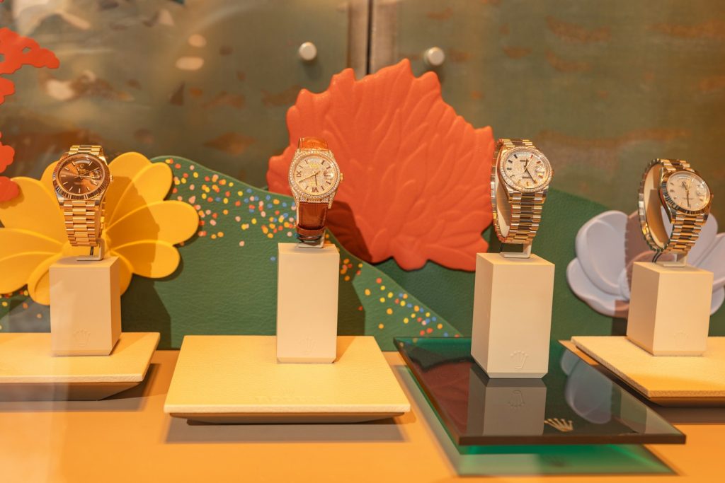 Four watches displayed on stands