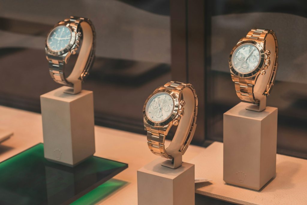 Three chronograph watches on white mounts