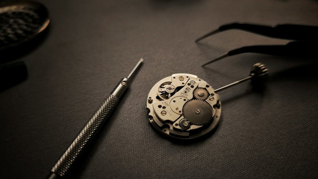 Watch movement beside watchmaking tools