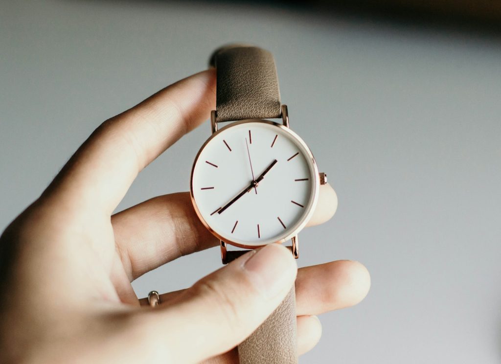 Person holding an analog watch