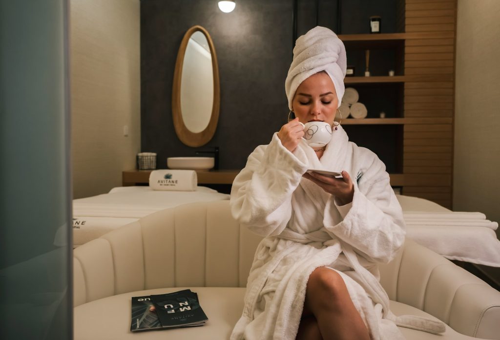 Woman in white robe relaxing on a couch