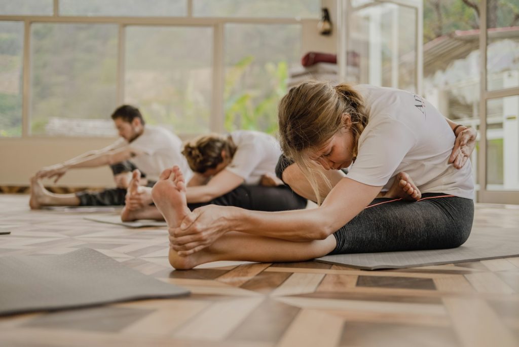 Group practicing yoga together in a bright room