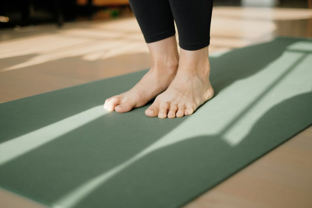 Person standing on a yoga mat
